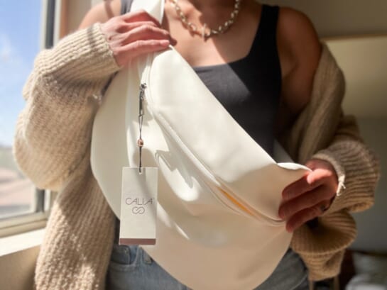 woman holding white crossbody bag
