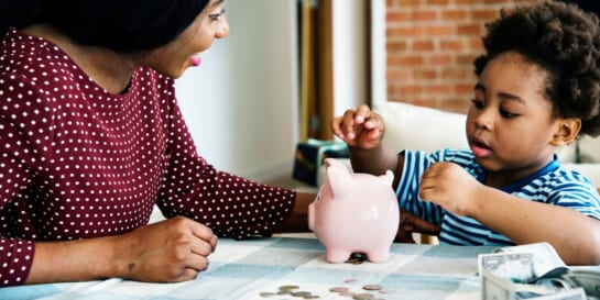 mom teaching son about money - money lessons to teach kids